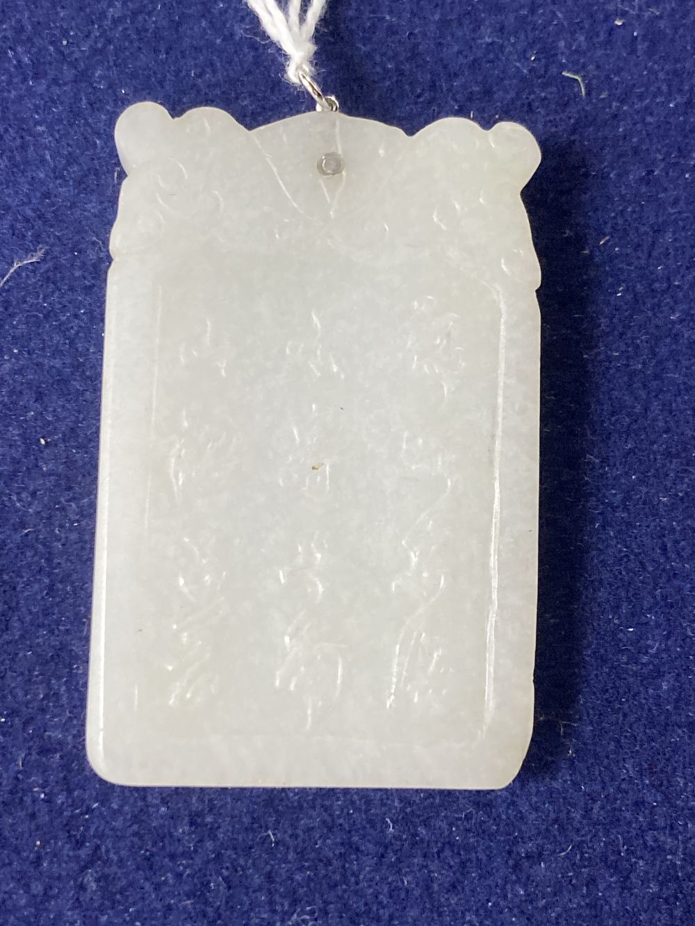 A Chinese diamond set white metal mounted carved white jade pendant, 57mm, gross 35.7 grams.